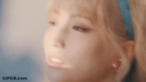 A Close Up Of A Woman 'S Face With Blonde Hair And A Blue Headband . GIF