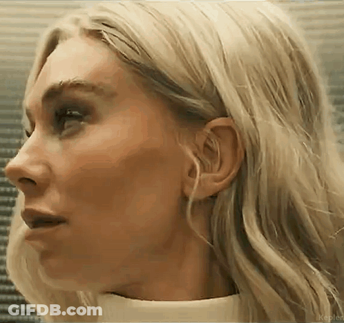 A Close Up Of A Woman 'S Face With Blonde Hair And A White Shirt . GIF