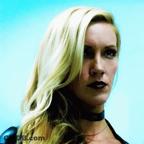 A Close Up Of A Woman 'S Face With Blonde Hair And Black Lips GIF