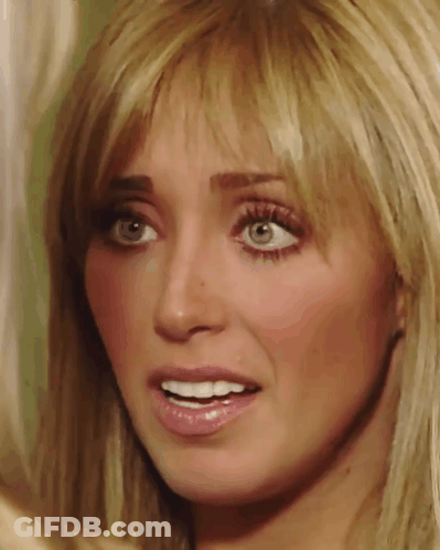 A Close Up Of A Woman 'S Face With Blonde Hair And Green Eyes GIF