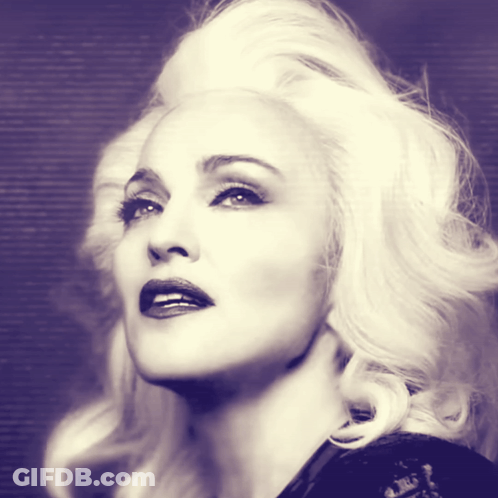 A Close Up Of A Woman 'S Face With Blonde Hair And Red Lips GIF
