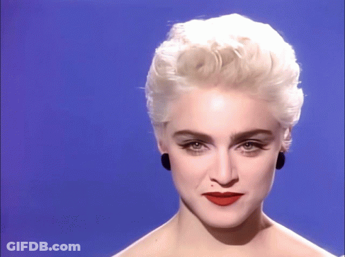 A Close Up Of A Woman 'S Face With Blonde Hair And Red Lips GIF