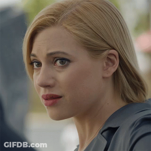 A Close Up Of A Woman 'S Face With Blonde Hair And Red Lipstick GIF