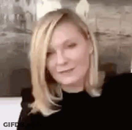 A Close Up Of A Woman 'S Face With Blonde Hair . GIF