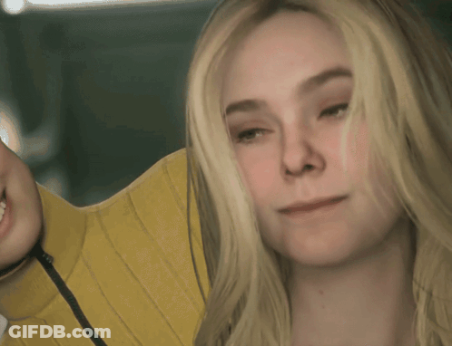 A Close Up Of A Woman 'S Face With Blonde Hair GIF