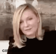 A Close Up Of A Woman 'S Face With Blonde Hair . GIF