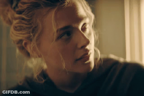A Close Up Of A Woman 'S Face With Blonde Hair GIF