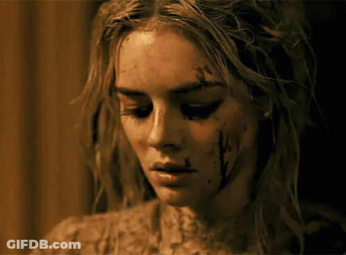 A Close Up Of A Woman 'S Face With Blood On Her Face GIF