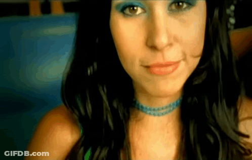 A Close Up Of A Woman 'S Face With Blue Eye Shadow GIF