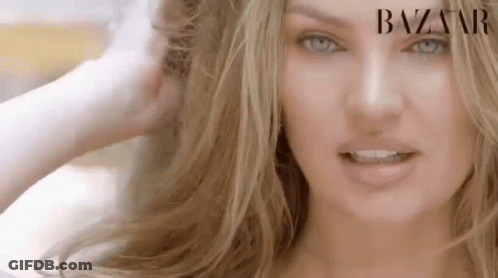 A Close Up Of A Woman 'S Face With Blue Eyes And Blonde Hair . GIF