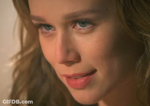 A Close Up Of A Woman 'S Face With Blue Eyes And Red Lips GIF