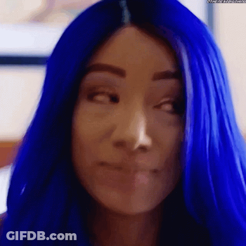 A Close Up Of A Woman 'S Face With Blue Hair GIF