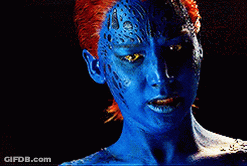 A Close Up Of A Woman 'S Face With Blue Paint On It GIF