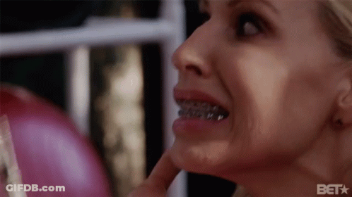A Close Up Of A Woman 'S Face With Braces On Her Teeth And A Bet Logo In The Corner GIF