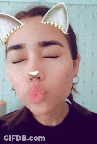 A Close Up Of A Woman 'S Face With Cat Ears On GIF