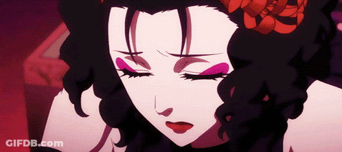A Close Up Of A Woman 'S Face With Closed Eyes And A Flower In Her Hair GIF