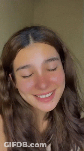 A Close Up Of A Woman 'S Face With Closed Eyes GIF