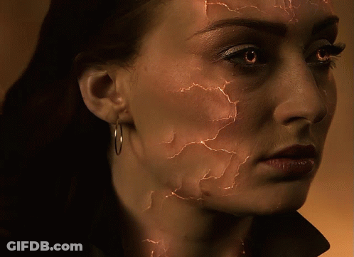 A Close Up Of A Woman 'S Face With Cracks GIF