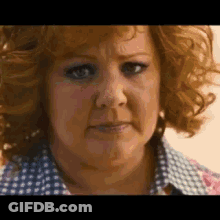 A Close Up Of A Woman 'S Face With Curly Red Hair . GIF