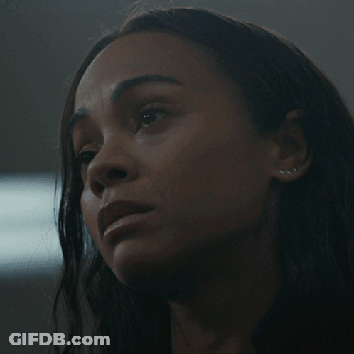 A Close Up Of A Woman 'S Face With Dark Hair GIF