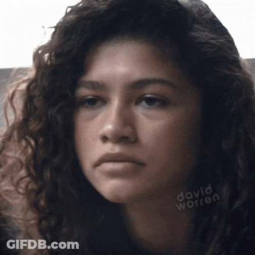 A Close Up Of A Woman 'S Face With David Worren Written On The Bottom Right GIF
