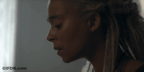 A Close Up Of A Woman 'S Face With Dreadlocks On Her Hair GIF