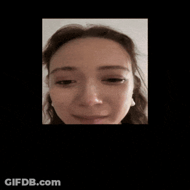 A Close Up Of A Woman 'S Face With Earrings GIF