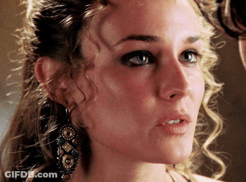 A Close Up Of A Woman 'S Face With Earrings On Her Ear GIF