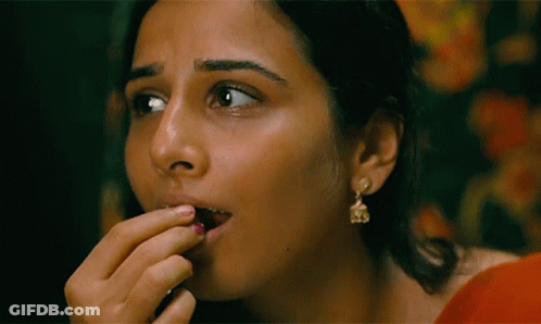 A Close Up Of A Woman 'S Face With Earrings On GIF