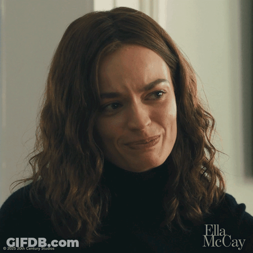 A Close Up Of A Woman 'S Face With Ella Mccay In The Corner GIF