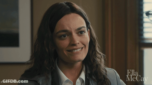 A Close Up Of A Woman 'S Face With Ella Mccay On The Bottom GIF
