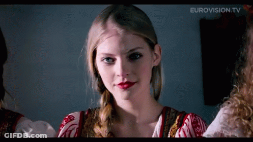 A Close Up Of A Woman 'S Face With Eurovision.tv In The Upper Right Corner GIF