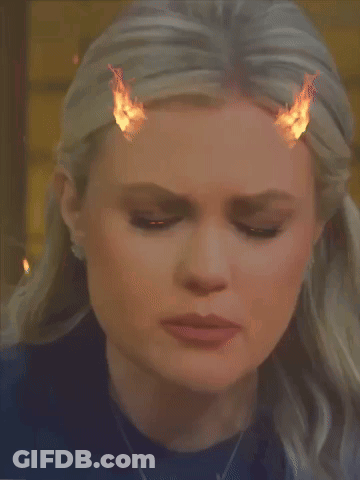 A Close Up Of A Woman 'S Face With Fire Coming Out Of Her Hair GIF