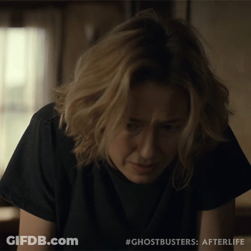 A Close Up Of A Woman 'S Face With #Ghostbusters Afterlife On The Bottom GIF