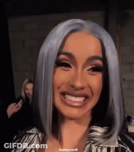 A Close Up Of A Woman 'S Face With Gray Hair And A Smile . GIF