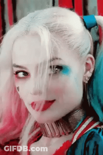 A Close Up Of A Woman 'S Face With Harley Quinn Makeup GIF