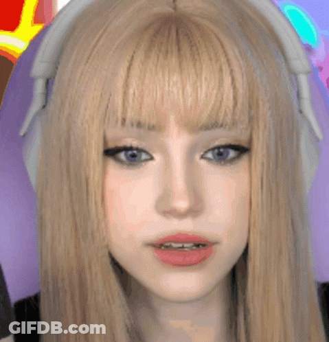A Close Up Of A Woman 'S Face With Headphones On . GIF