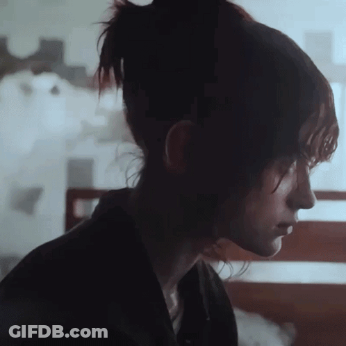 A Close Up Of A Woman 'S Face With Her Eyes Closed GIF