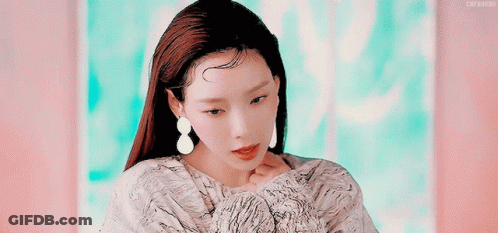 A Close Up Of A Woman 'S Face With Her Eyes Closed GIF