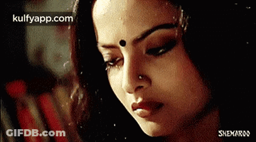 A Close Up Of A Woman 'S Face With Her Eyes Closed GIF
