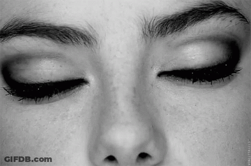 A Close Up Of A Woman 'S Face With Her Eyes Closed And Her Eyebrows Visible . GIF