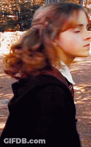 A Close Up Of A Woman 'S Face With Her Eyes Closed And Her Hair Blowing In The Wind GIF