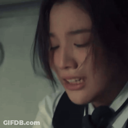 A Close Up Of A Woman 'S Face With Her Eyes Closed And Her Hair Blowing In The Wind GIF