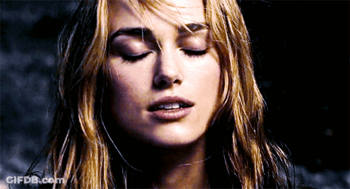 A Close Up Of A Woman 'S Face With Her Eyes Closed And Her Hair Blowing In The Wind GIF