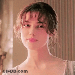 A Close Up Of A Woman 'S Face With Her Eyes Closed And Her Hair In A Bun . GIF