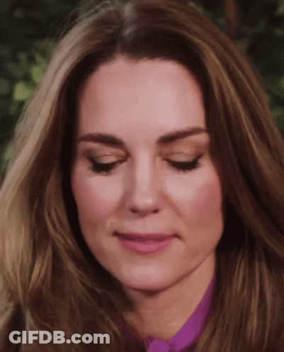 A Close Up Of A Woman 'S Face With Her Eyes Closed And Her Mouth Open . GIF