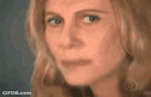 A Close Up Of A Woman 'S Face With Her Eyes Closed And Her Mouth Open . GIF