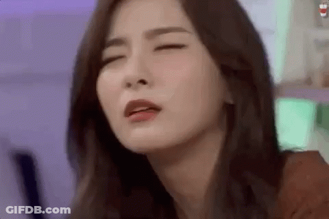 A Close Up Of A Woman 'S Face With Her Eyes Closed And Her Mouth Open . GIF