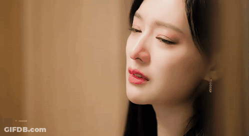 A Close Up Of A Woman 'S Face With Her Eyes Closed And Her Mouth Open . GIF