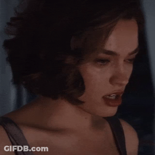 A Close Up Of A Woman 'S Face With Her Eyes Closed And Her Mouth Open . GIF